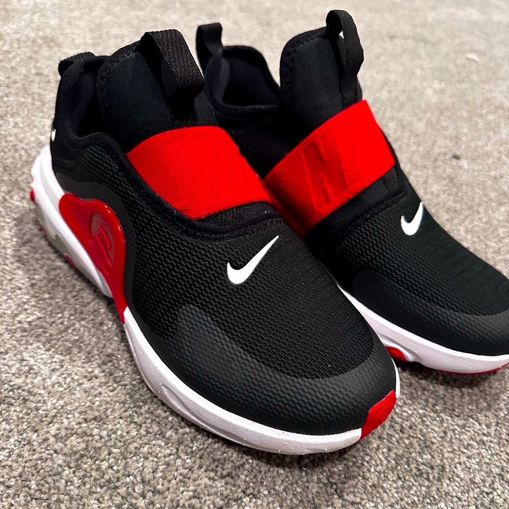 Red black and white Nike shoes. Size 5 women’s never worn feel free to offer.